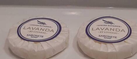 Two round soap bars on a white surface.