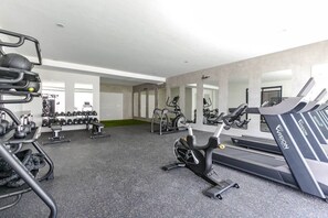 A gym with treadmills, weight machines, and free weights.