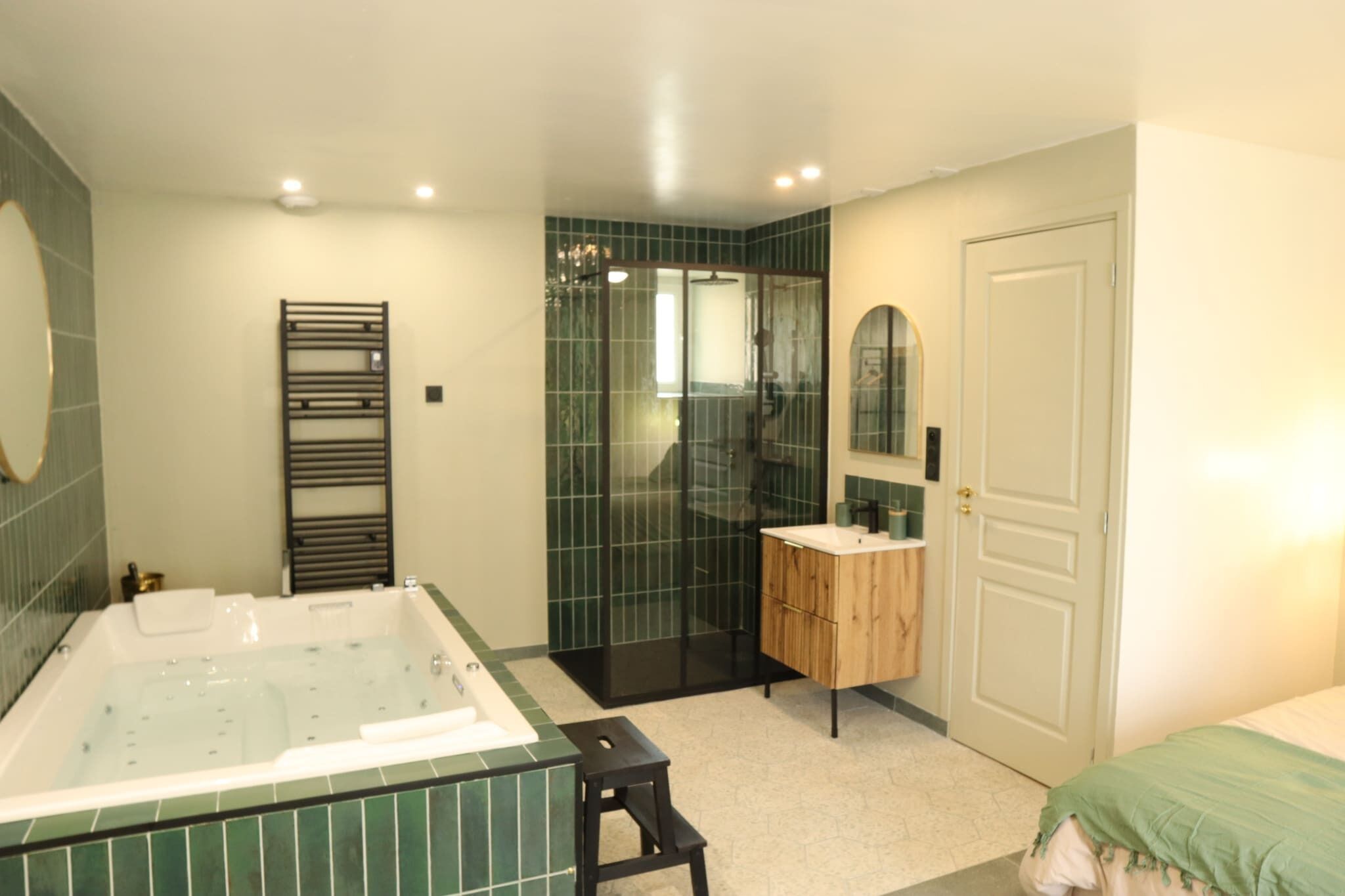 A modern bathroom with a freestanding bathtub, a glass-enclosed shower, and a wooden vanity.
