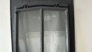 A window with a decorative frame and a clear glass pane.