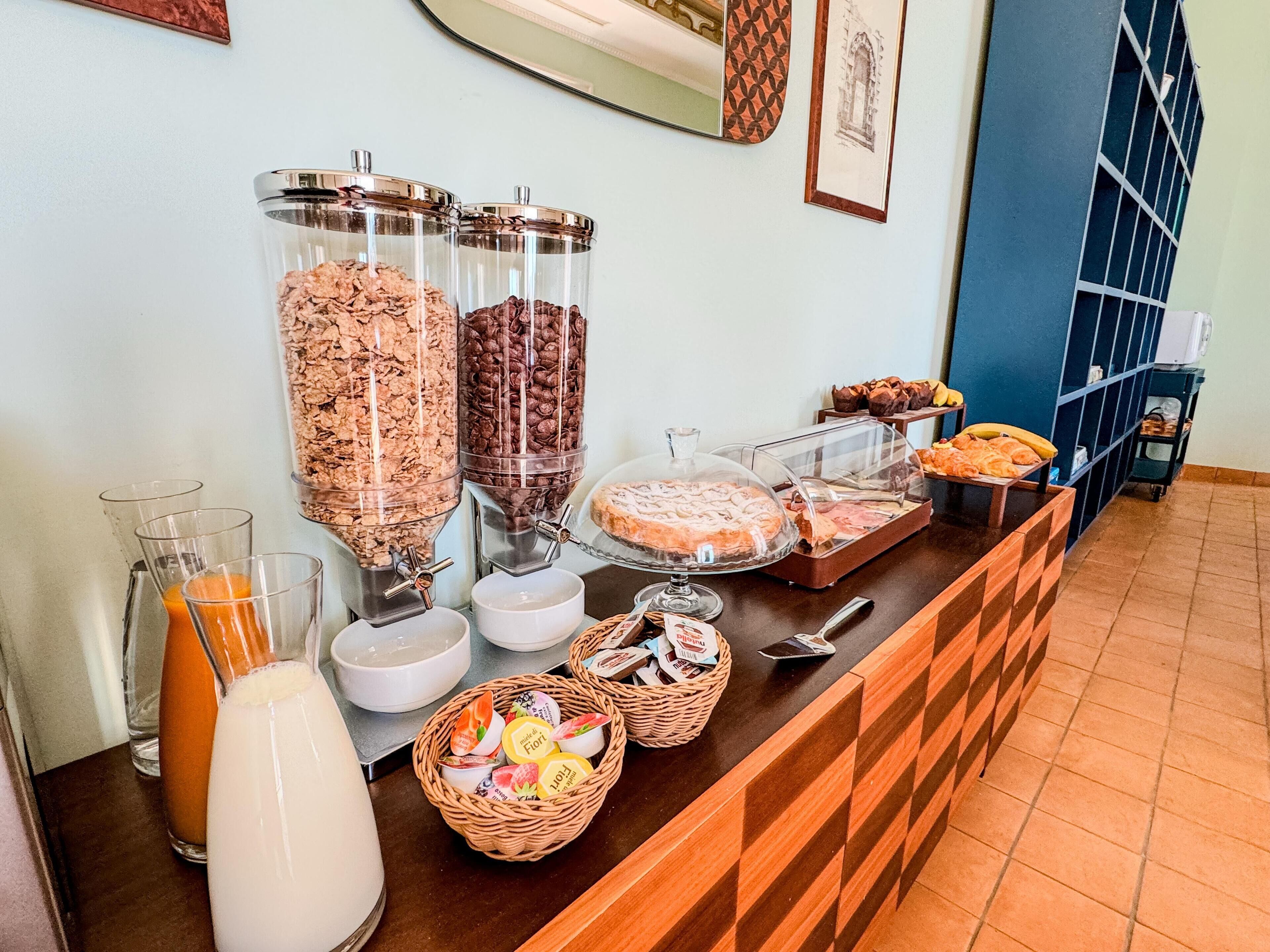 A breakfast buffet with granola, chocolate, and pastries.