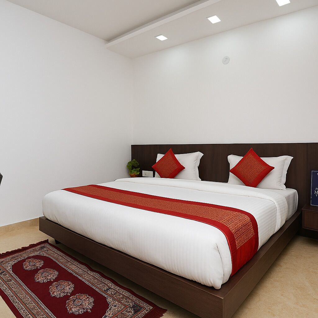 A modern bedroom with a large bed, a red and white bedspread, and a red patterned rug.