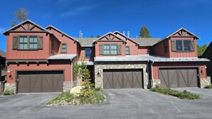 A two-story house with a stone foundation and a red exterior. - Snowcreek Resort Vacation Rental 1555 (Mammoth Lakes)