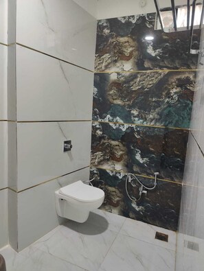Deluxe Quadruple Room | Bathroom | Shower, free toiletries, slippers, towels - Hotel Bhavya (Ujjain)