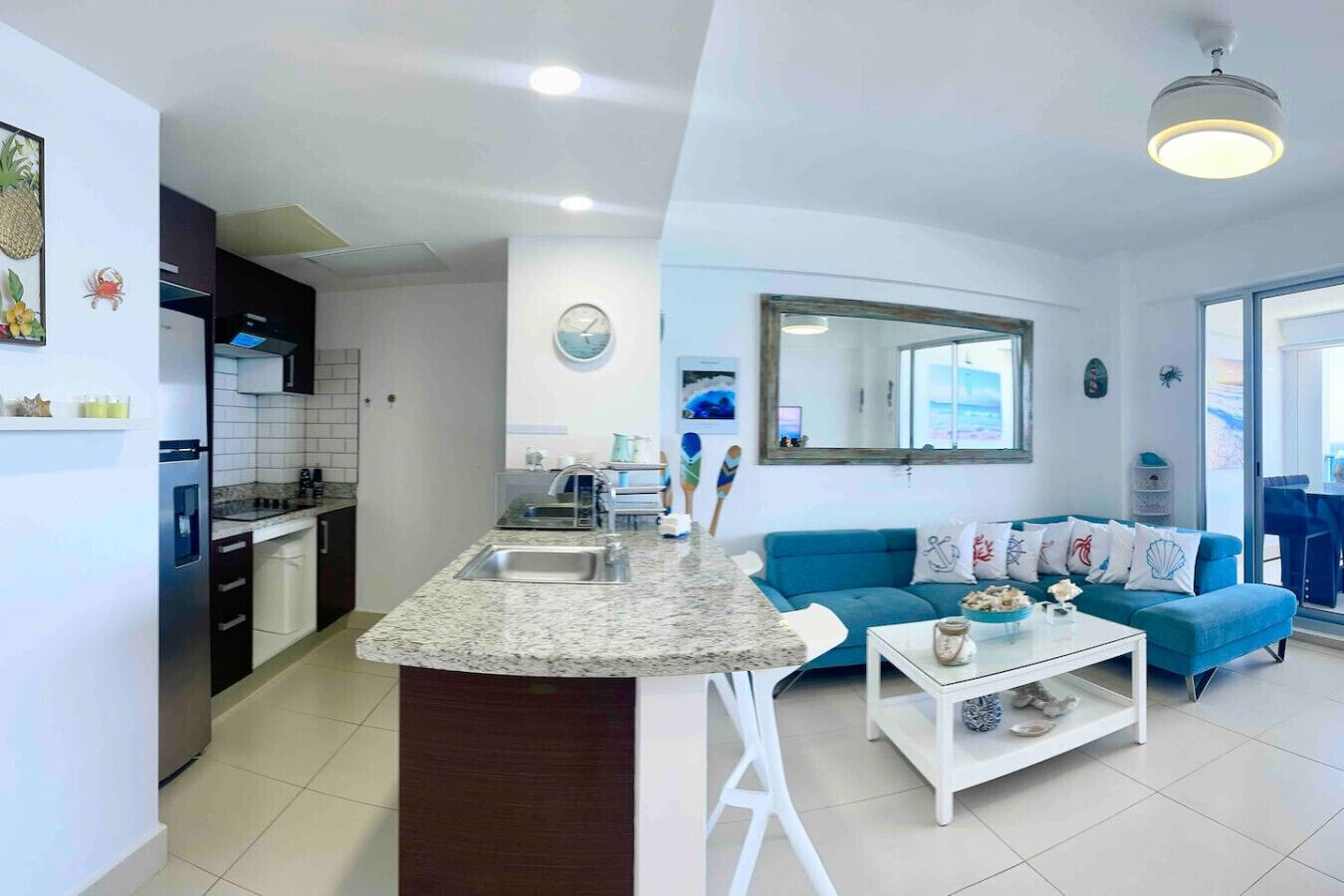 A modern apartment with a kitchen, dining area, and living room.