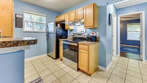 A kitchen with wooden cabinets, a stainless steel refrigerator, an oven, and a dishwasher. - 4 Mi to Dtwn Jacksonville: Game Day Escape! (Jacksonville)