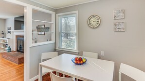 A dining area with a white table, a blue fruit bowl, and a clock on the wall. - < 1 Mi to Craigville Beach: Home w/ Patio & BBQ (Centerville)