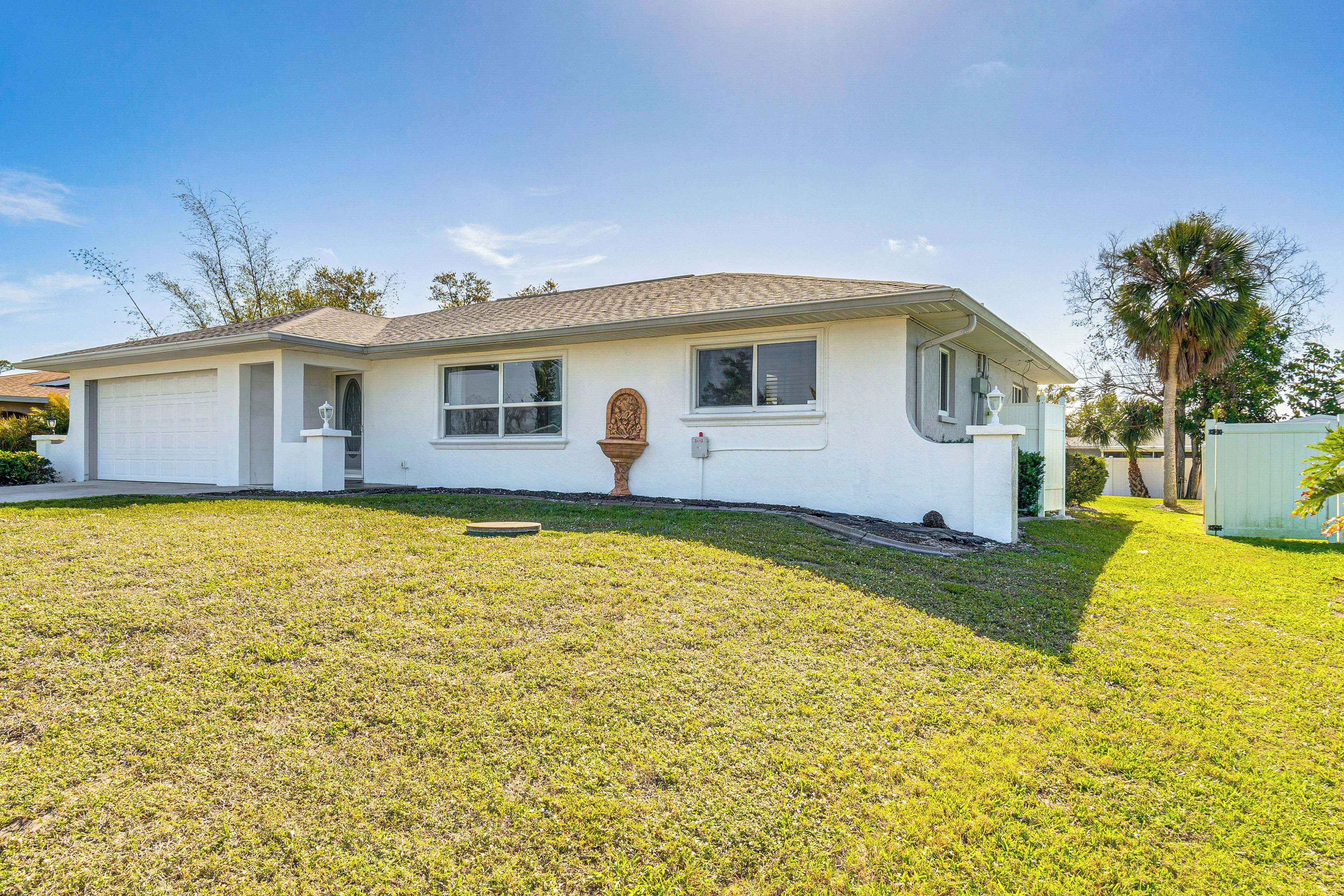 A single-story house with a garage, a front porch, and a well-maintained lawn.