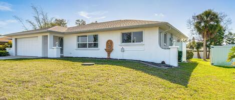A single-story house with a garage, a front porch, and a well-maintained lawn.