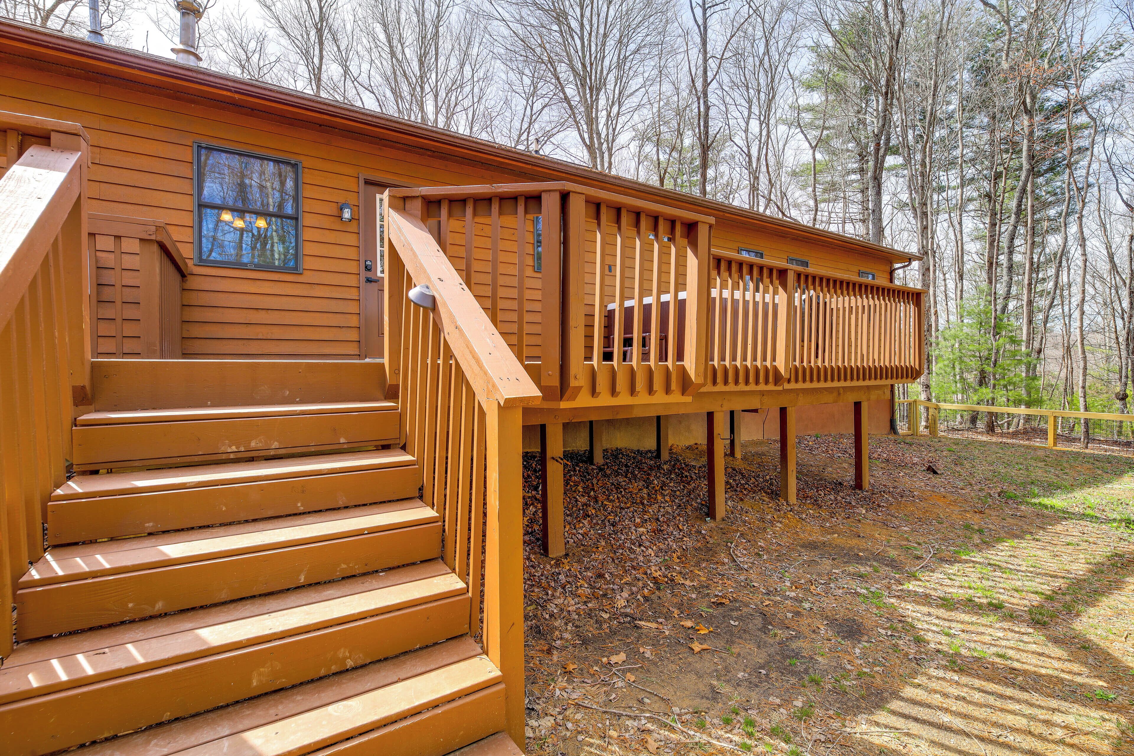 A wooden cabin with a staircase leading to a deck.