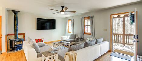 A modern living room with a sofa, coffee table, and a fireplace.