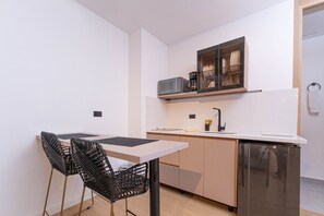 Fridge, microwave, coffee/tea maker, cookware/dishes/utensils
