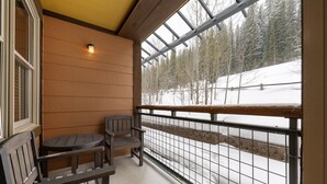 A wooden balcony with a view of a snow-covered landscape. - Premium Unit 1305 - Zephyr Mountain Lodge 1 Bedroom Condo (Winter Park)