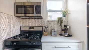 Gas stove, knife block, microwave, toaster, and plenty of cooking utensils so making meals is a breeze.