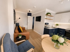 Un apartamento moderno con sala de estar, comedor y cocina.