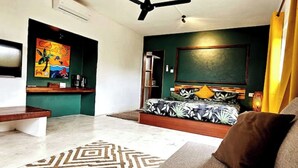 A modern bedroom with a bed, a desk, and a chair. - Mapou Studio Apartment with Pool 15min from Grand Bay (Mauritius)