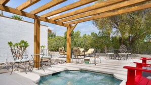 A backyard with a hot tub, wooden pergola, and outdoor furniture. - Casa Chiquita: HUGE Backyard, Heated Pool & Spa (Palm Springs)