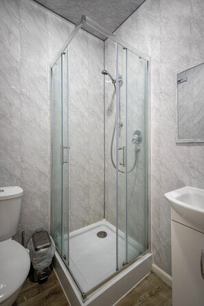 Shower, towels, shampoo, toilet paper