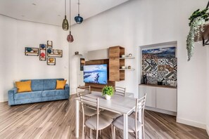 Deluxe Apartment, Balcony, City View | Living area | Flat-screen TV
