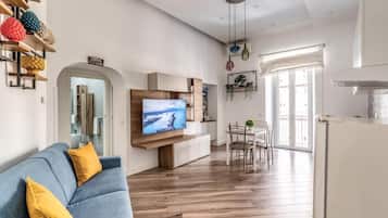 Deluxe Apartment, Balcony, City View | Living area | Flat-screen TV