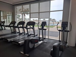 A gym with treadmills, elliptical machines, and a stationary bike.
