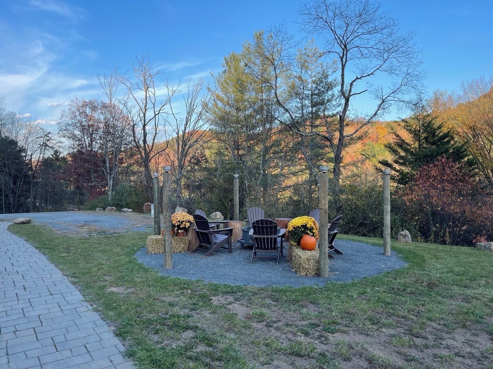 A patio area with outdoor seating and decorative elements like pumpkins and flowers.