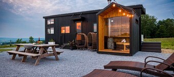 we invite u to come experience this off grid tiny home on top of a grassy hilltop.