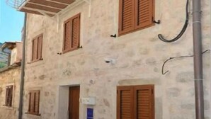 A multi-story building with a balcony, air conditioning units, and a door. - Villa Madonna della Strada A 3 (Dubrovnik)