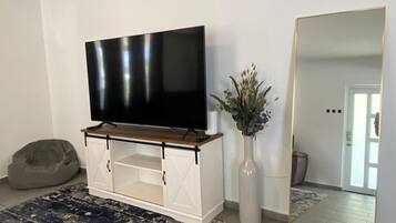 Comfort House, Balcony, Poolside | Living room | TV
