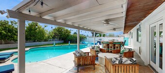 Modern retro-style home w/ game room, heated pool, large yard & covered patio