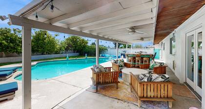 Modern retro-style home w/ game room, heated pool, large yard & covered patio