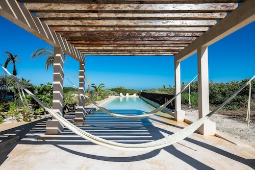 Beachfront apartment with private balcony, heated pool & stunning views