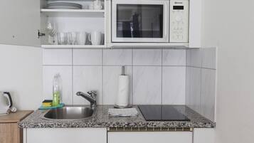 Microwave, stovetop, coffee/tea maker, cookware/dishes/utensils