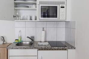 Microwave, stovetop, coffee/tea maker, cookware/dishes/utensils