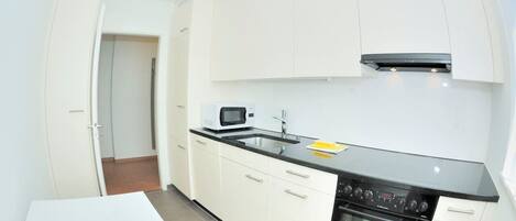 Een koelkast, een oven, een kookplaat, een vaatwasser