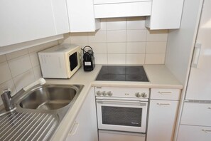 Fridge, stovetop, dishwasher, coffee/tea maker