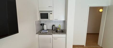 Microwave, stovetop, coffee/tea maker, cookware/dishes/utensils