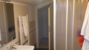 A bathroom with a white sink, mirror, and glass shower enclosure. - 5 minutes walk from the beach - New Apartment with 2 bedrooms in Italy (Giulianova)