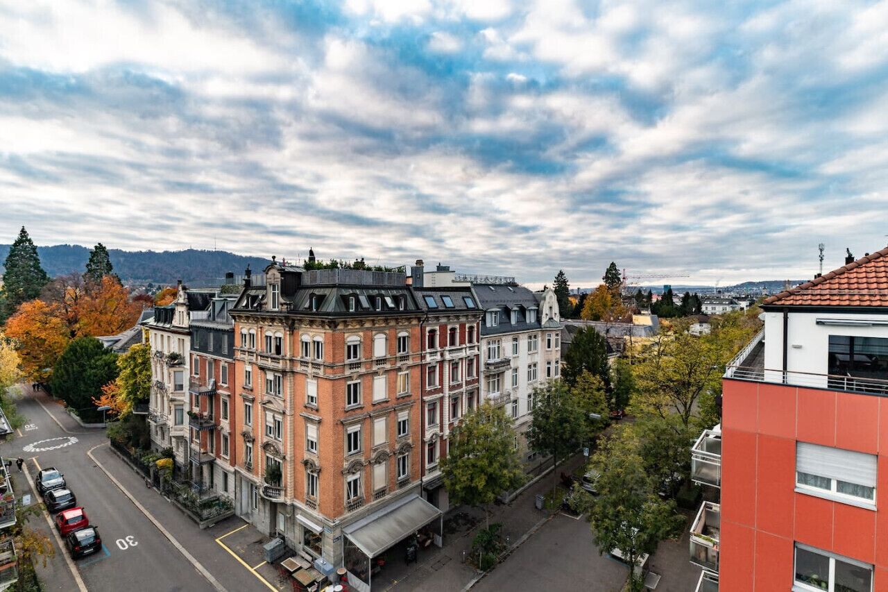 A multi-story building with a classic architectural style, featuring a prominent corner entrance and a flat roof.