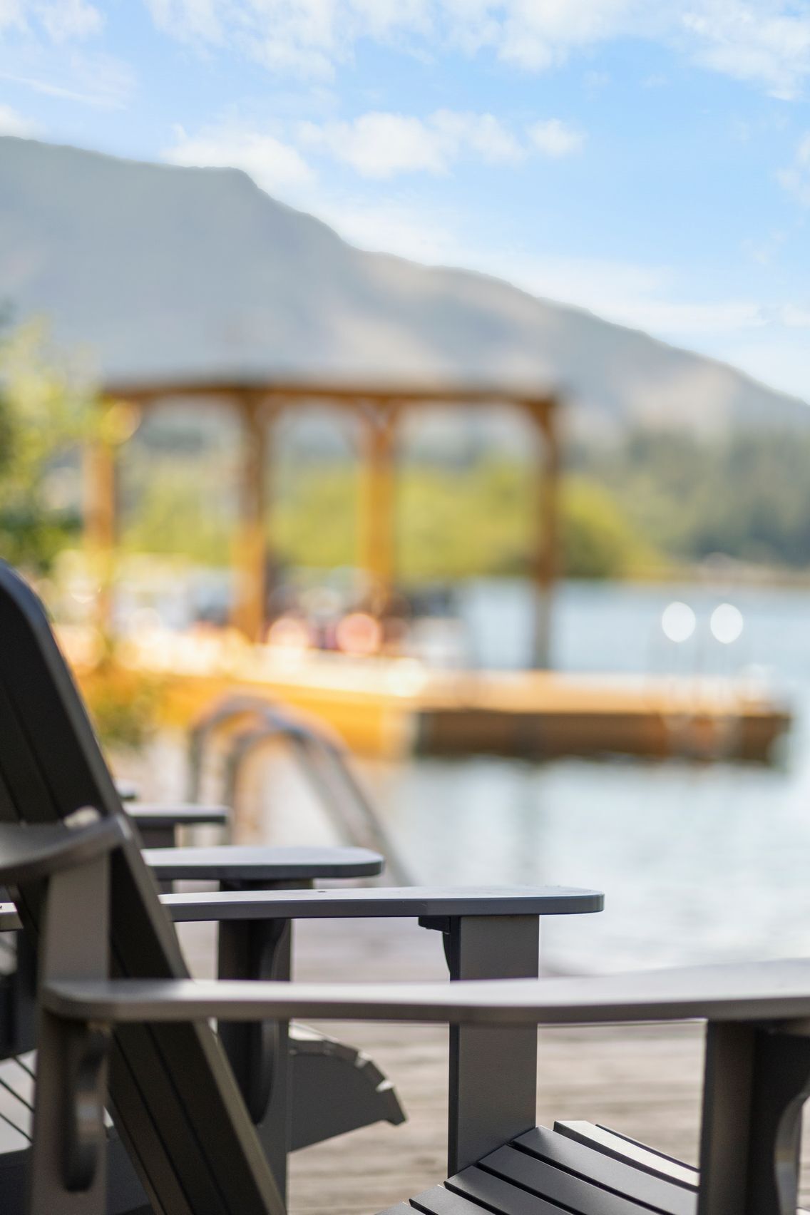 A lakeside patio with a gazebo in the background.