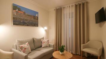 Family Suite, Balcony, Garden View | Living area | Flat-screen TV