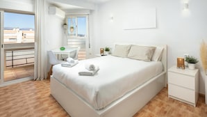 A modern bedroom with a large bed, a desk, and a balcony. - Apartment 'Plazamar 039' with Sea View, Wi-Fi and Air Conditioning (Torre del Mar)