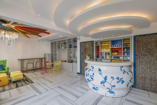 A modern hotel lobby with a reception desk, seating area, and a decorative ceiling. - Your City Pinghua Impression Inn (Kunshan)