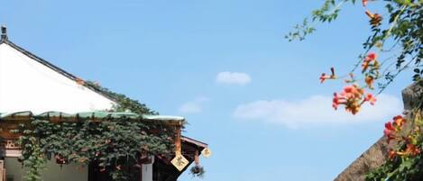 A traditional building with a tiled roof and a circular structure at the base.