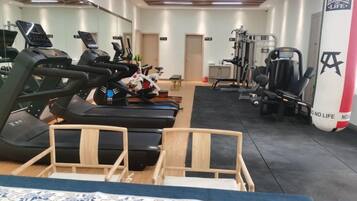 A gym with treadmills, stationary bikes, and weight machines.