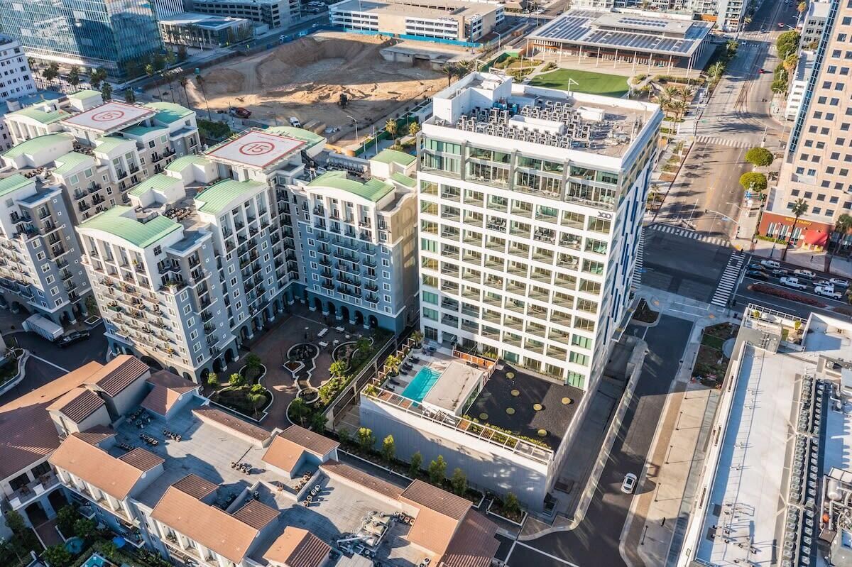 A high-rise hotel with multiple floors, a rooftop pool, and a central courtyard.