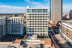 A modern hotel with a central courtyard, multiple floors, and a mix of glass and concrete facades. - @ Marbella Lane - Panoramic Delight Dream Escape! (Long Beach)