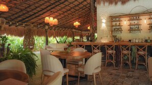 A rustic bar area with wooden furniture and hanging lights. - Anzalik Hotel Boutique (Anza)
