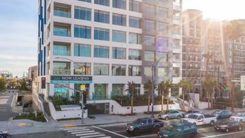 A modern multi-story building with a 'Now Leasing' sign, located at Ocean Blvd.