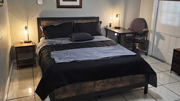 A bedroom with a bed, a desk, a chair, a ceiling fan, and a window with blinds. - HOME SWEET HOME, near USF, Bush Gardens, Adventure Island, MOSI, Downtown. (Tampa)